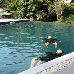 two people floating in a pool