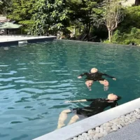 two people floating in a pool