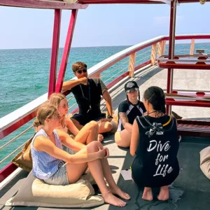 A group of scuba divers during the dive plan briefing on the boat